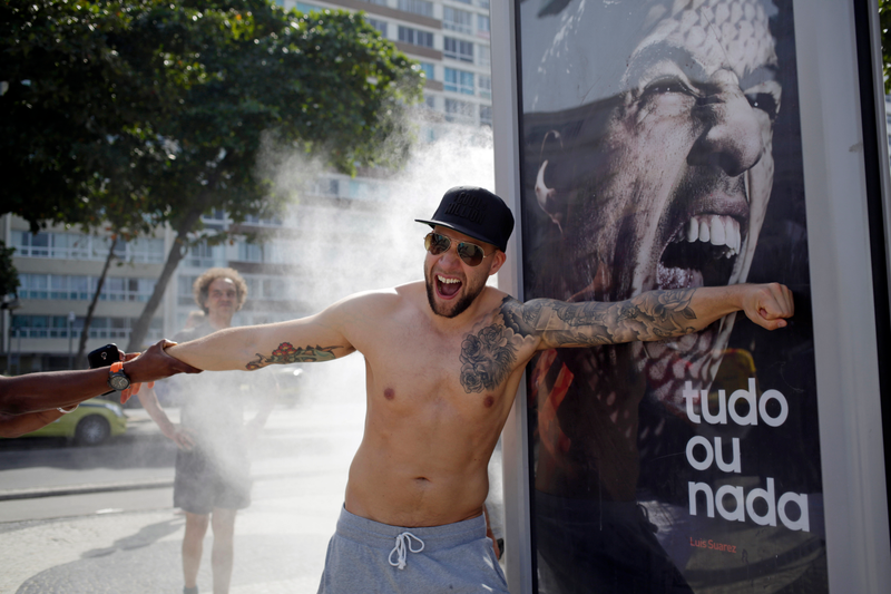 Illustration for article titled People In Rio Are Doing Funny Things With A Luis Suárez Billboard